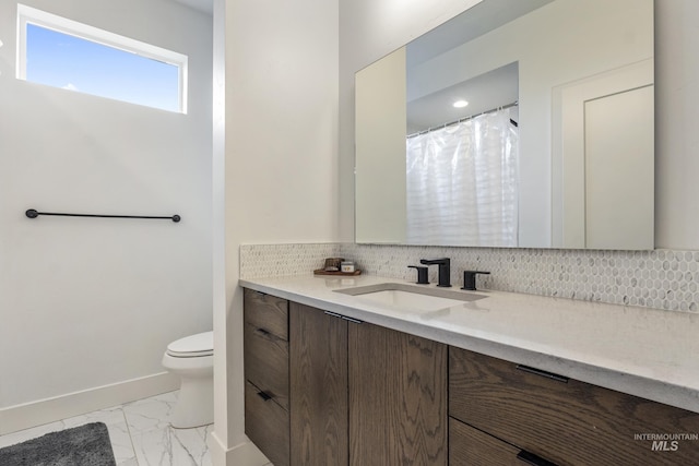 bathroom featuring decorative backsplash, marble finish floor, vanity, and toilet