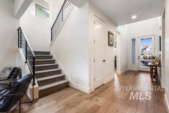 stairway featuring recessed lighting, baseboards, and hardwood / wood-style flooring