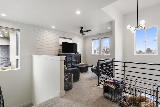 interior space with carpet floors, recessed lighting, baseboards, and ceiling fan with notable chandelier