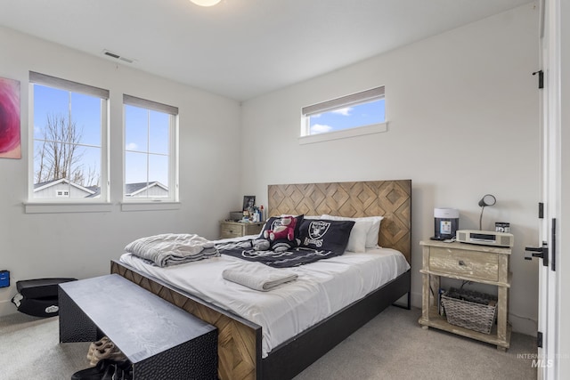 carpeted bedroom featuring visible vents