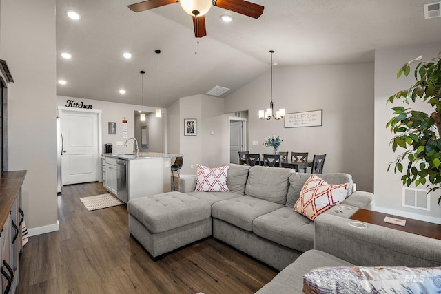 living room with lofted ceiling, dark wood-type flooring, ceiling fan with notable chandelier, and sink