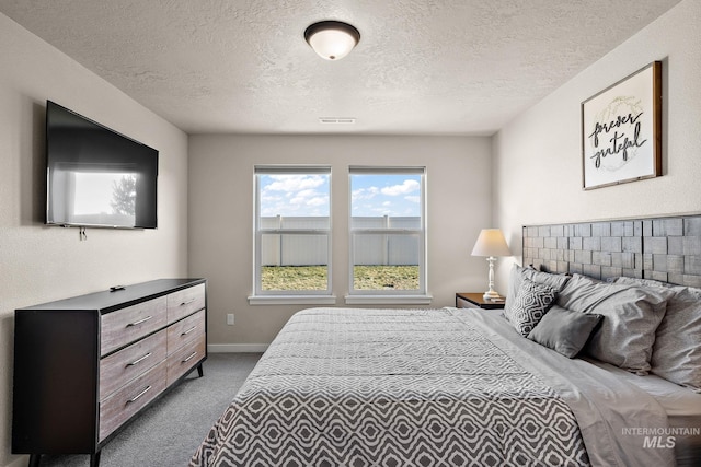 carpeted bedroom with a textured ceiling