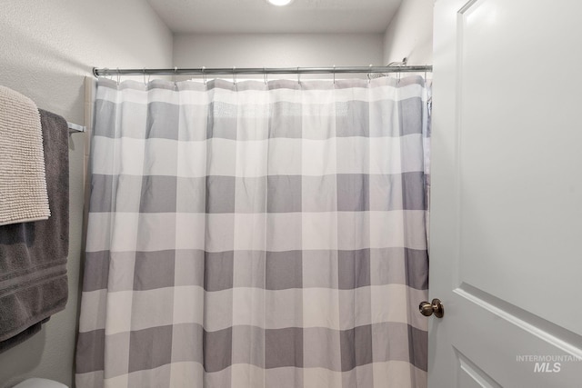 bathroom with curtained shower