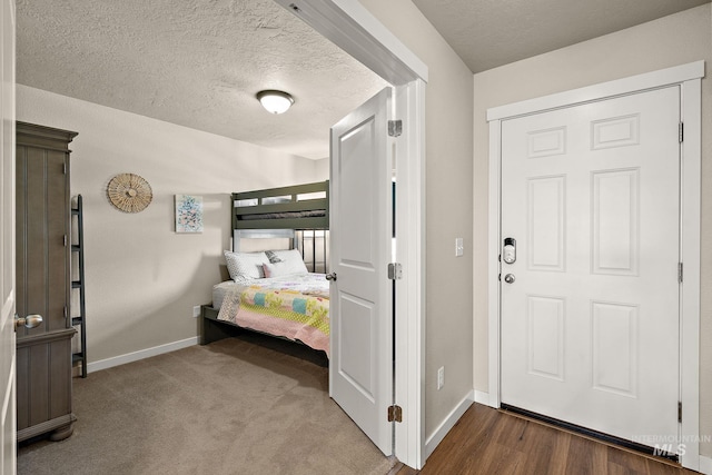 bedroom featuring wood-type flooring and a textured ceiling