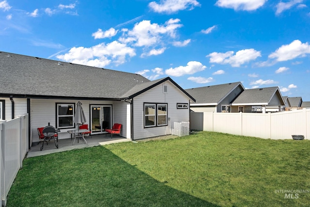 rear view of property featuring a yard and a patio