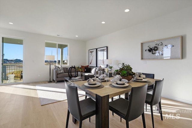 dining space with recessed lighting, light wood-type flooring, and baseboards