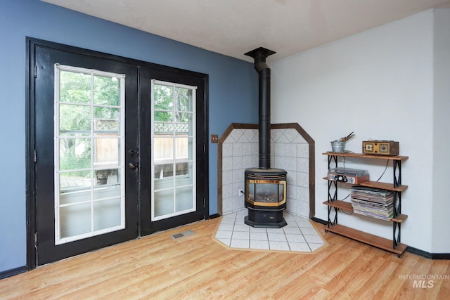 731 W 4th St, Emmett, ID 83617 - doorway to outside featuring french doors, a wood stove, and wood finished floors