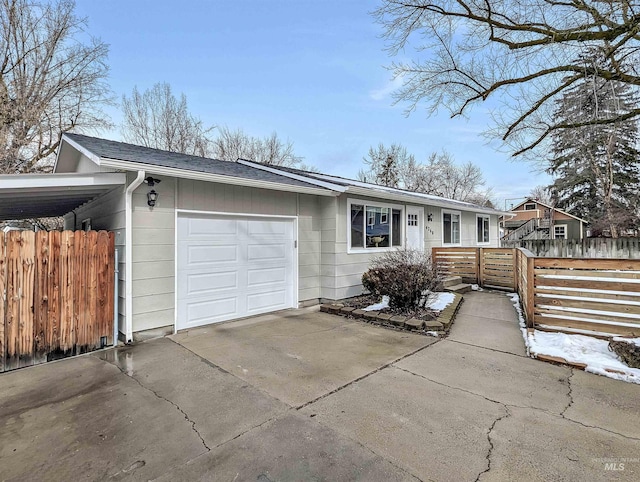 ranch-style home with a garage and a carport