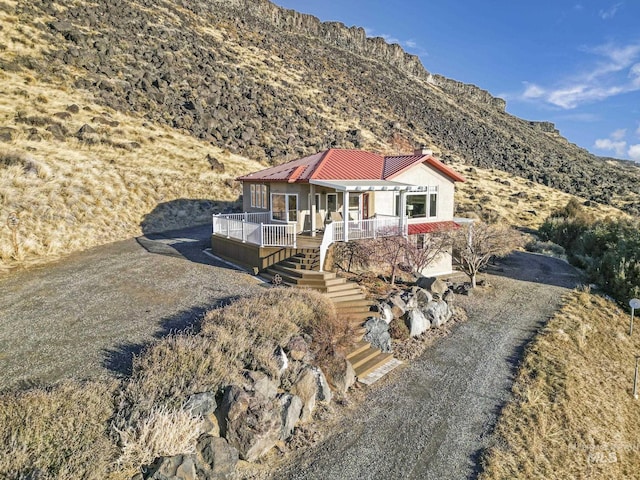 view of front of home with a mountain view and a porch