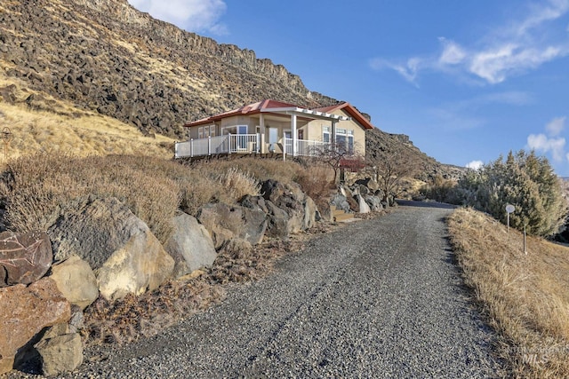 view of front of property with a mountain view and a porch