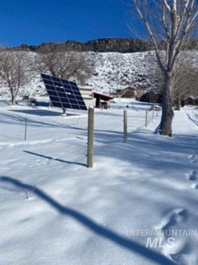 snowy yard featuring a mountain view