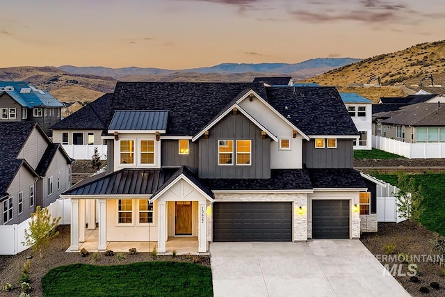 modern inspired farmhouse with a garage and a mountain view