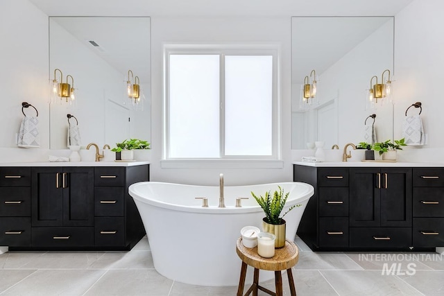 bathroom featuring vanity, a tub, and tile patterned floors