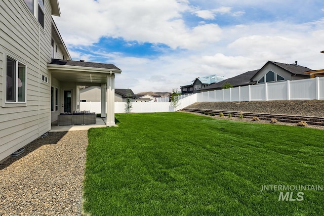 view of yard with an outdoor living space and a patio