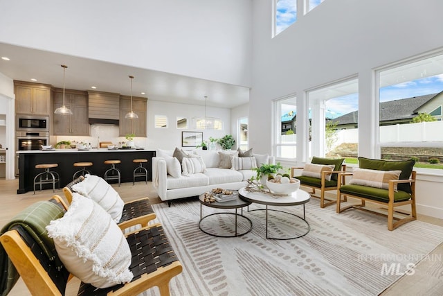 living room with a towering ceiling and plenty of natural light