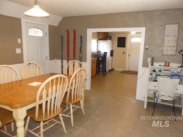 dining area featuring lofted ceiling