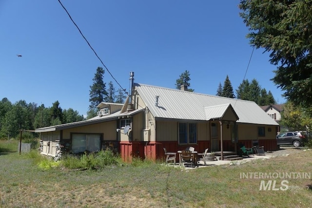 rear view of house with metal roof