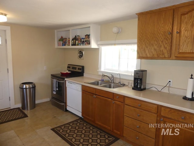 kitchen featuring dishwasher, electric stove, brown cabinets, light countertops, and a sink