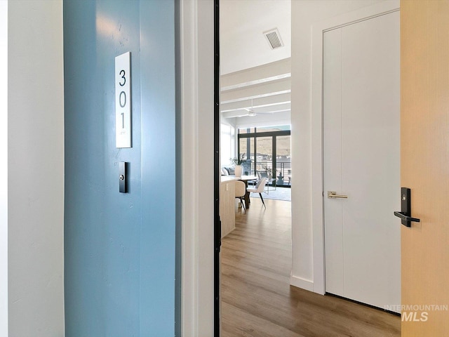 hallway with light hardwood / wood-style flooring