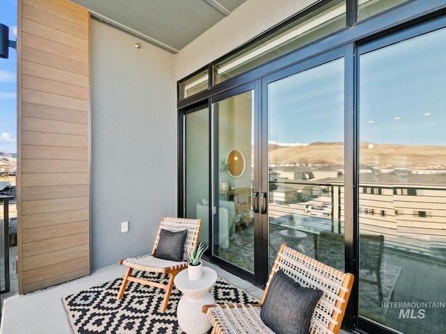 balcony featuring french doors and a mountain view