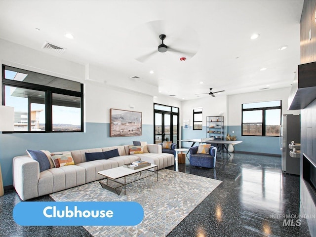 living room with ceiling fan and plenty of natural light