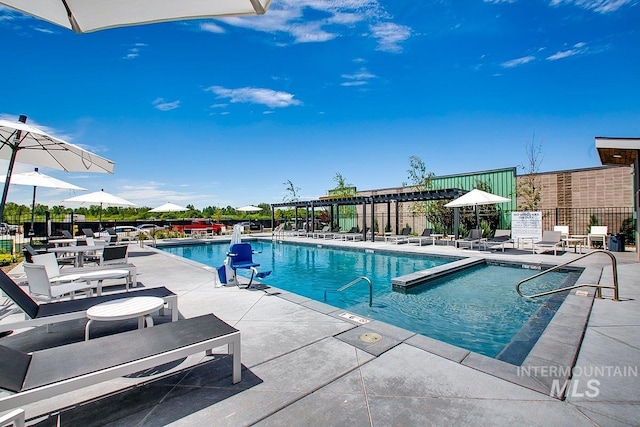 view of pool with a pergola and a patio area