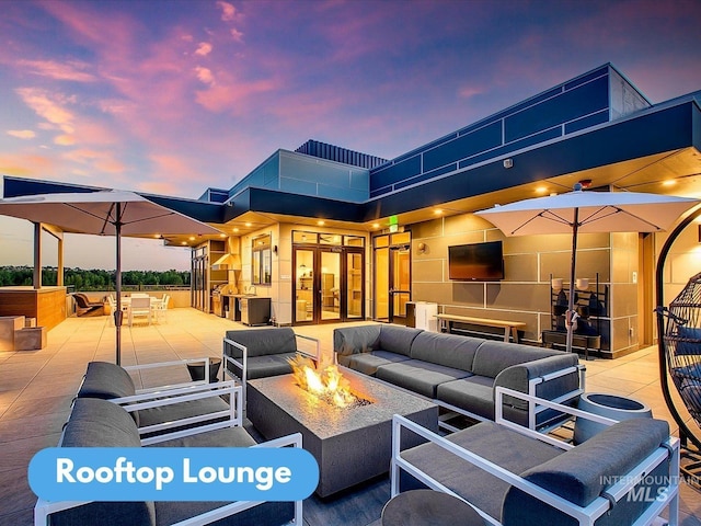 view of patio / terrace featuring an outdoor living space with a fire pit