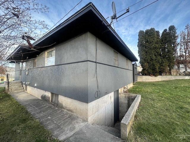 view of home's exterior with a lawn