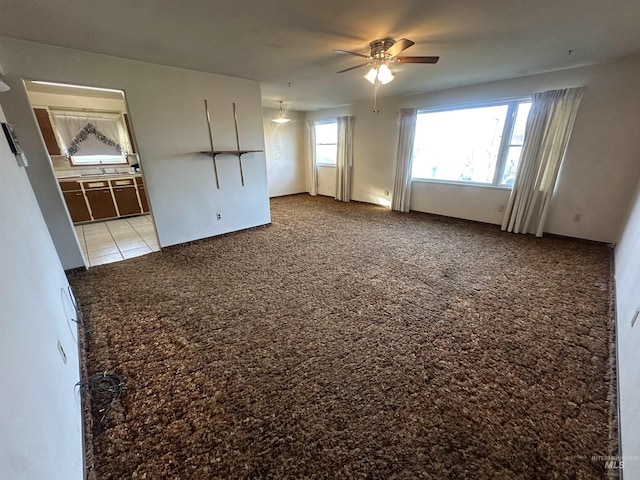 carpeted spare room with ceiling fan