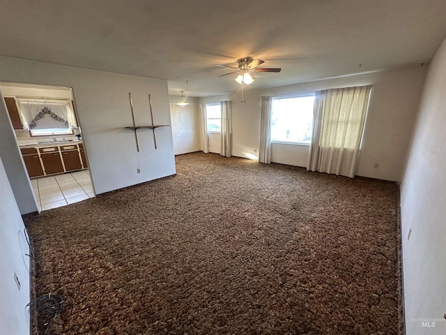 empty room with ceiling fan and light colored carpet