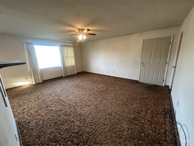 empty room featuring ceiling fan and carpet floors