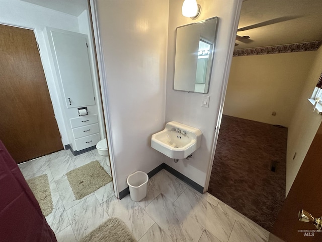 bathroom featuring toilet and sink