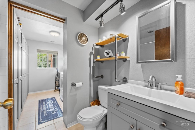 full bath with track lighting, tile patterned floors, baseboards, vanity, and toilet