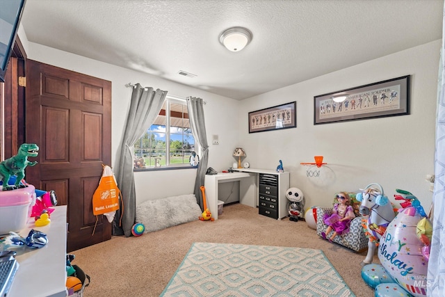 bedroom featuring visible vents, a textured ceiling, and light colored carpet