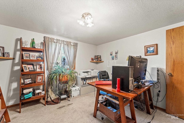home office featuring carpet floors and a textured ceiling