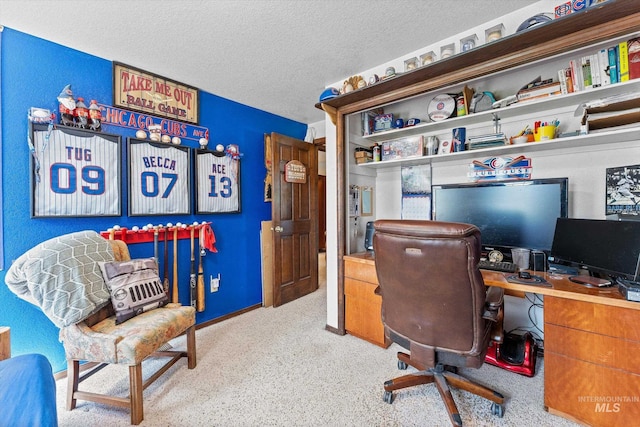 carpeted office featuring a textured ceiling
