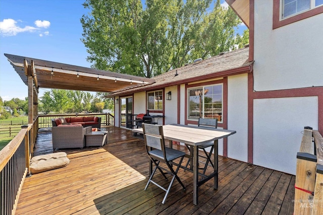 wooden terrace with outdoor dining area and outdoor lounge area