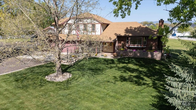 view of front facade featuring a chimney and a front lawn