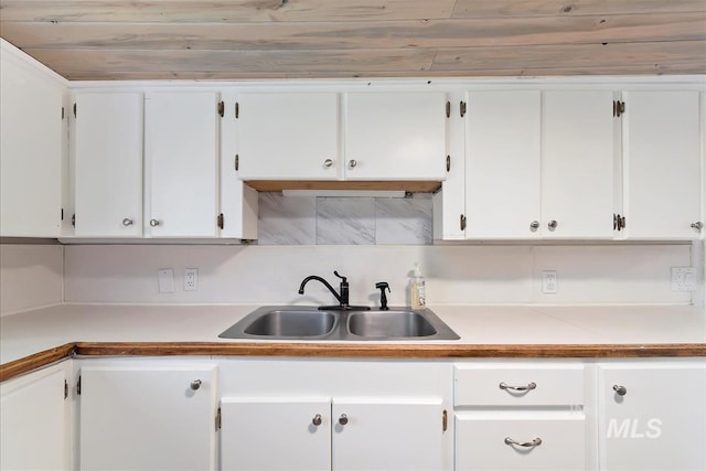 216 9th Ave N, Nampa, ID 83687 - kitchen with a sink, white cabinetry, tasteful backsplash, and light countertops