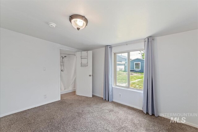 216 9th Ave N, Nampa, ID 83687 - empty room with carpet flooring, lofted ceiling, and baseboards