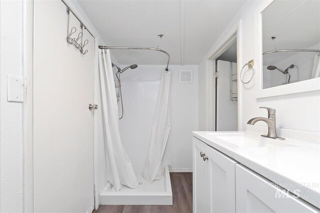 216 9th Ave N, Nampa, ID 83687 - full bathroom with wood finished floors, vanity, and curtained shower