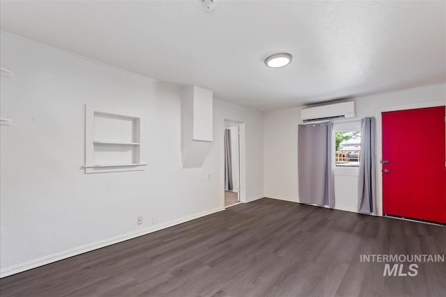 216 9th Ave N, Nampa, ID 83687 - unfurnished living room featuring a wall mounted AC, wood finished floors, and baseboards