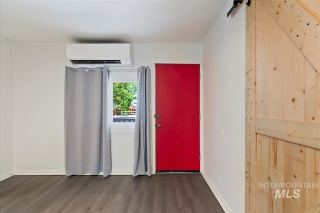216 9th Ave N, Nampa, ID 83687 - foyer entrance featuring a wall mounted air conditioner, wood finished floors, a barn door, and baseboards