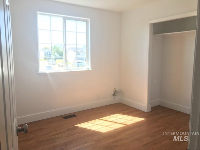 unfurnished bedroom featuring dark hardwood / wood-style flooring