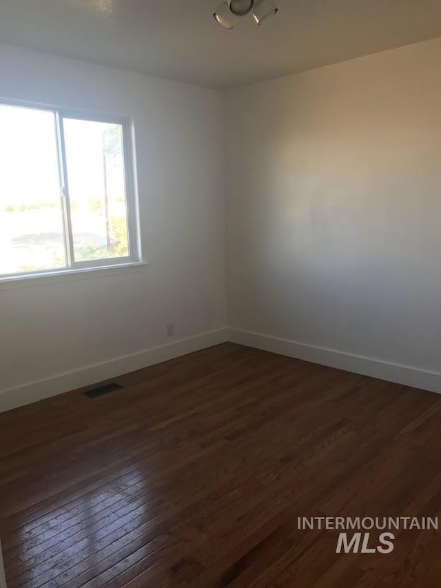 empty room featuring dark wood-type flooring