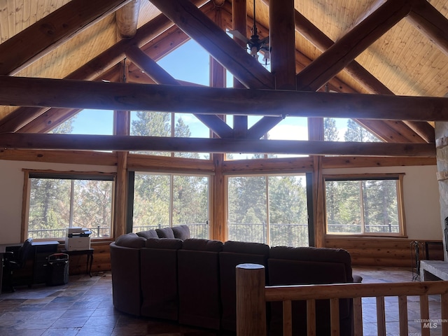 living room featuring plenty of natural light, lofted ceiling with beams, and wood ceiling