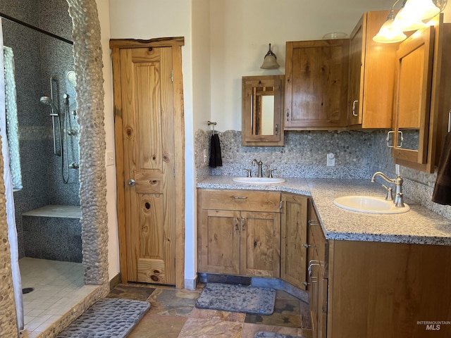 bathroom featuring vanity, decorative backsplash, and walk in shower