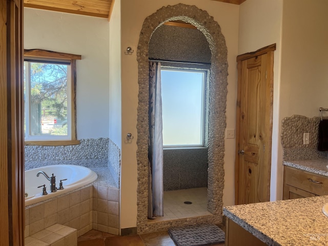 bathroom with tile patterned flooring, vanity, and shower with separate bathtub