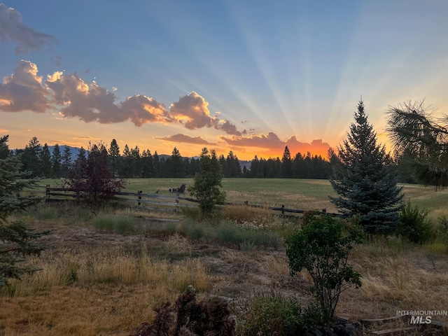 nature at dusk featuring a rural view