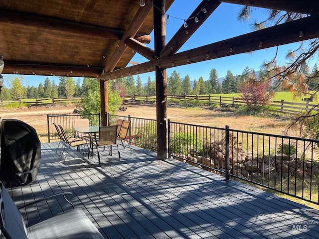 wooden deck featuring a rural view and a grill